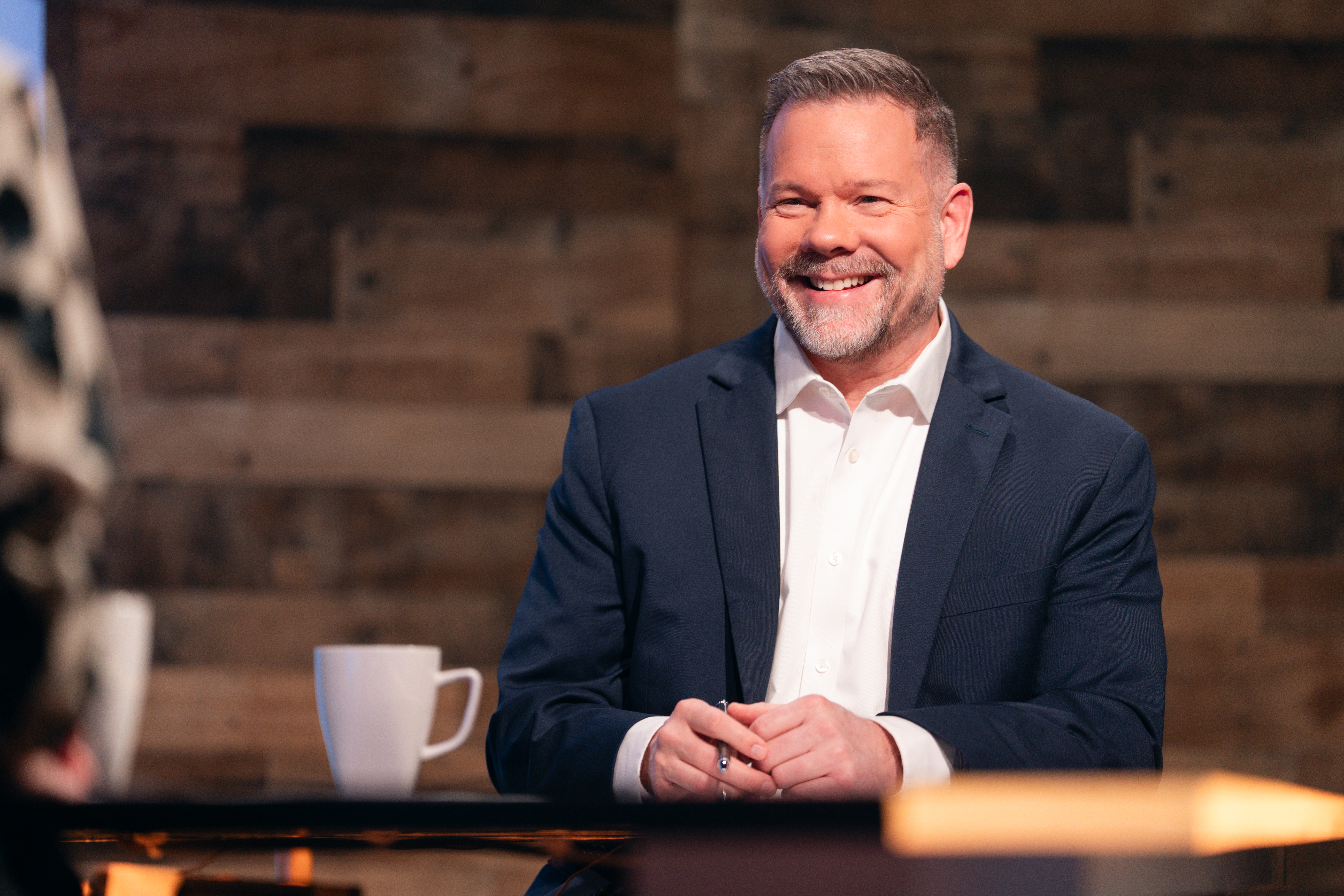 Chris Owens laughing at interview desk